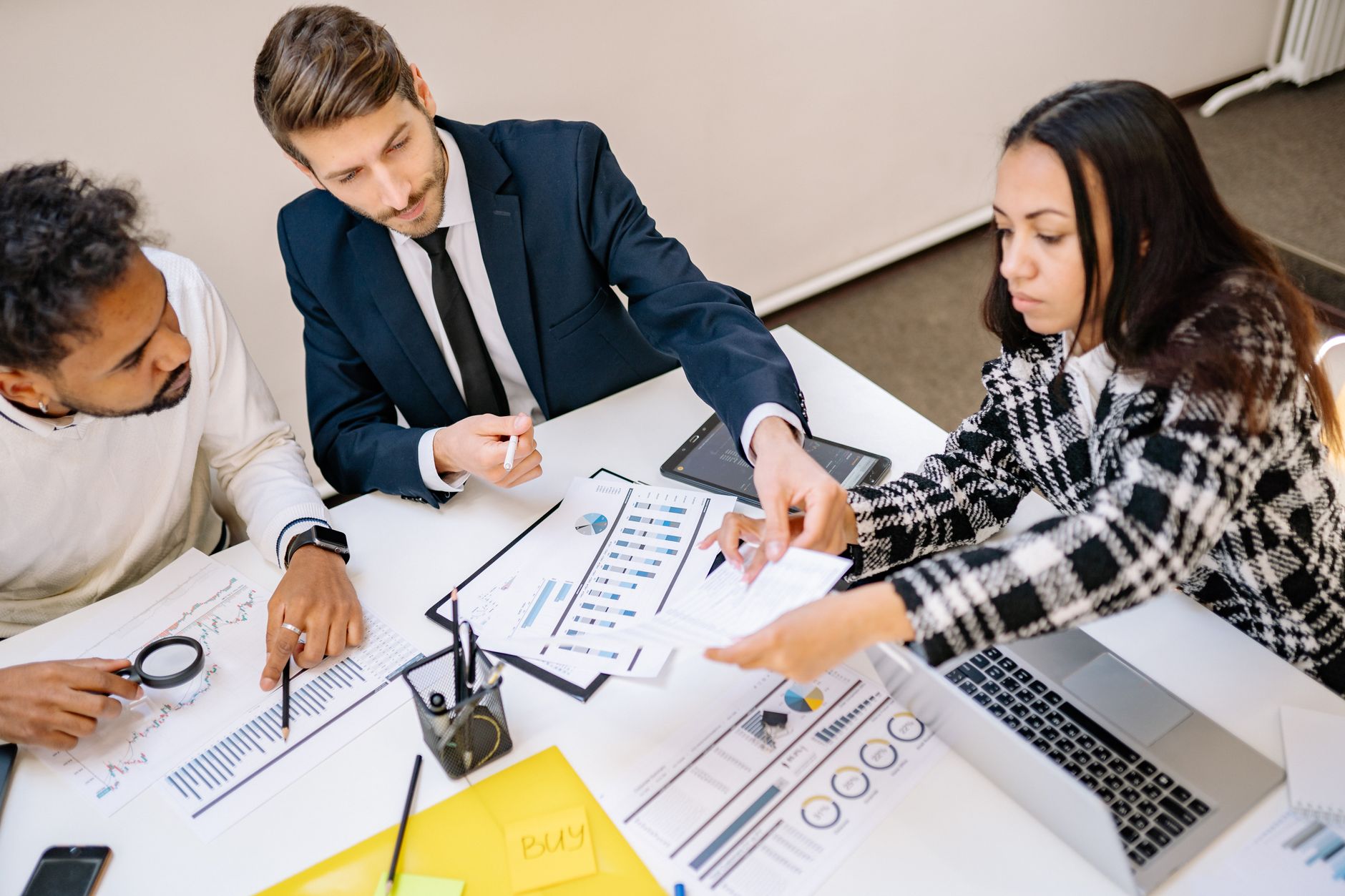 Group of professionals reviewing blueprints and documents of a real estate project